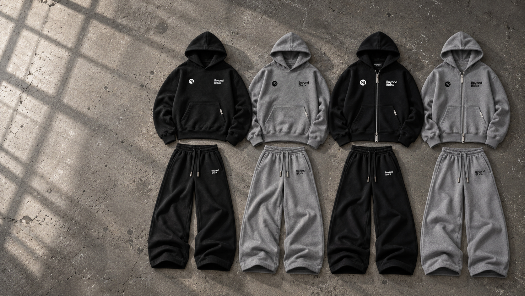 Black and grey NOIRIX zip and pullover sets arranged as a collection